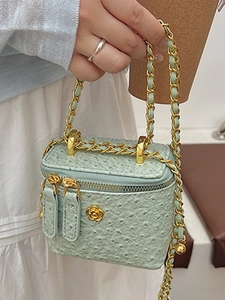 Mint green ostrich leather box bag with gold chain and camellia flower ornament