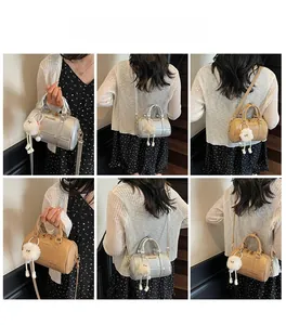 Detail shots of elegant litchi grain mini Boston bag with plush ball charms