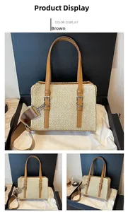 Detail view of straw woven crossbody bag with brown leather handles and silver hardware