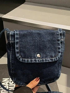 Retro deep blue denim crossbody bag with white stitching and silver metal button detail