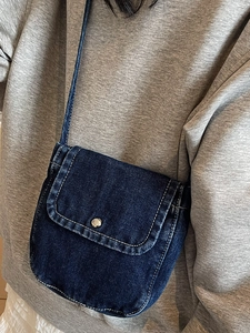 Vintage dark blue denim crossbody bag with contrast stitching and metal buckle closure
