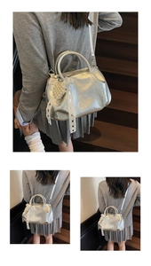 Detail of silver metallic pleated handbag featuring white lace bow and pearl charms