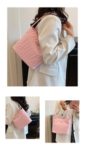 Detail shot of the pink pleated canvas tote bag with a small woven label on the front
