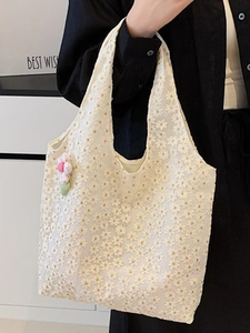 Off-white lace tote bag with floral embroidery and pink knitted flower charm