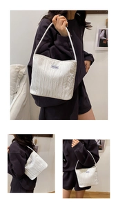 Detail showing white pleated quilted fabric texture and Ann's then label on tote bag