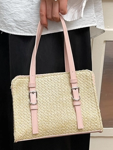 Fashionable straw woven shoulder bag with pink faux leather handles and metal buckles