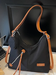 Large black nylon tote bag with brown leather straps and a mini round pouch for daily commuting