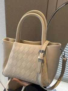 Chic cream quilted small bucket bag with dual handles and adjustable shoulder strap