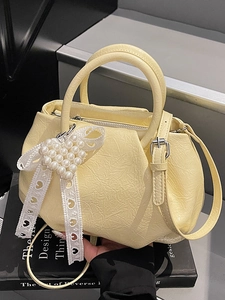 Summer pleated cream handbag with elegant pearl bow charm and crossbody strap