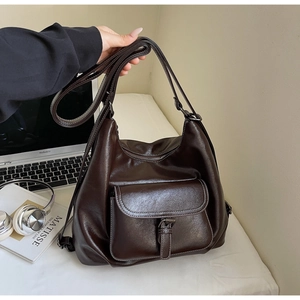 Close-up of retro large tote bag with buckle pocket and smooth brown PU leather texture