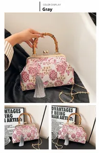Retro floral handbag with bamboo handle, metal frame, and elegant grey tassel details
