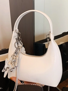 White patent leather half-moon shoulder bag with glossy finish and silver star charms