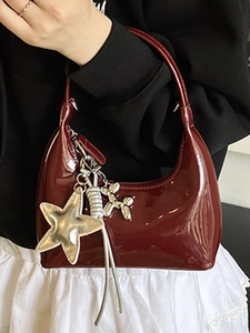 Glossy burgundy patent leather underarm bag with silver star and balloon dog charms