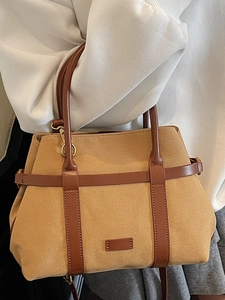 Sac seau classique en toile kaki et cuir marron, parfait pour un usage quotidien élégant