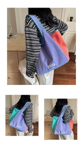 Detail view of the colorful color-block canvas tote bag with wide shoulder strap design