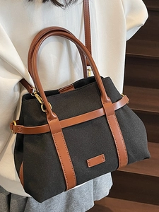 Sac seau chic en toile noire et cuir marron avec grande capacité et bandoulière réglable