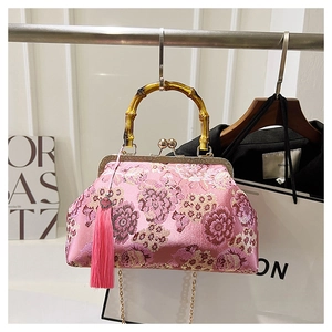Detail of pink silk embroidery with bamboo handle and elegant hanging tassel
