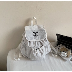 Detail of off-white nylon backpack featuring drawstring closure and MUTING embroidery