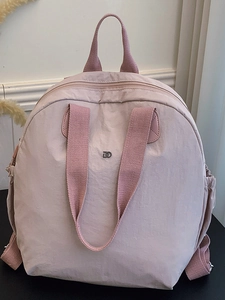 Lightweight pale pink puffy backpack for women made of waterproof nylon fabric