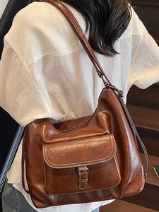Minimalist large brown leather tote bag with buckle flap pocket in vintage biker style
