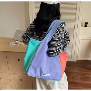 Detail of minimalist canvas tote with mint, lilac, and coral pink color-block design