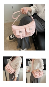 Pink crescent moon crossbody bag with utility pockets and adjustable shoulder strap