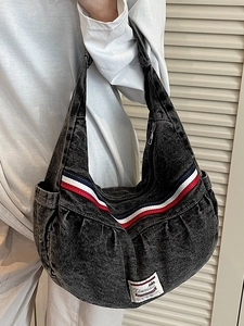 Fashionable denim hobo bag with snowflake wash texture and sporty striped strap