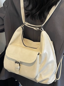 Minimalist cream white tote backpack with stylish belt buckle and convertible straps