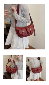 Detail view of burgundy faux leather half-moon bag featuring silver buckles and pockets