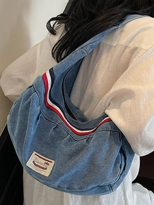 Blue denim hobo shoulder bag with tricolor ribbon trim and casual slouchy design