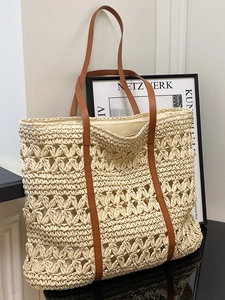 Minimalist straw tote bag with floral crochet patterns and brown leather handles