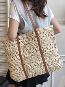 Women's woven straw beach tote bag with hollow flower pattern and brown leather straps