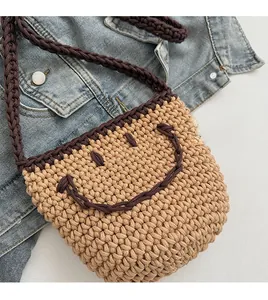 Detail of hand-woven bucket bag with straw smiley face and thick rope texture