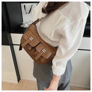 Detail view of brown faux leather hobo bag with multi-pocket design and silver hardware