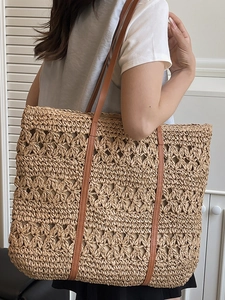Hollow straw woven beach tote bag with brown straps for summer vacation fashion