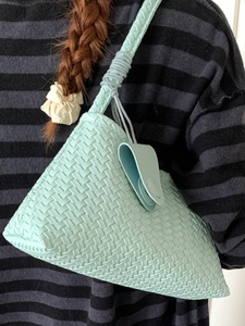 Elegant mint green woven leather hobo bag for women with a sleek triangular dumpling shape