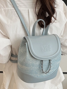 Light blue mini backpack for women featuring textured fabric and silver rivet details