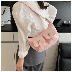 Detail of pink faux leather hobo bag with dual pockets and silver metal buckles