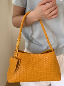 Elegant yellow woven leather hobo bag for women with decorative knot and small pouch