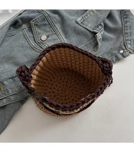Detail of hand-woven bucket bag with cat ear design and brown cotton rope texture