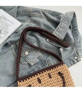 Detail of handwoven crochet bucket bag with khaki cotton rope and brown strap accents