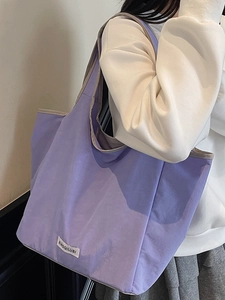 Minimalist lavender canvas tote bag with wide shoulder strap for daily commuting