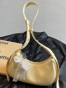Pale yellow croissant shoulder bag with pearl heart pendant on black leather