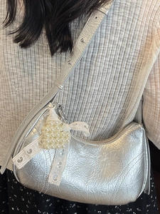 Chic silver metallic crescent underarm bag with pearl heart charm and rivet details