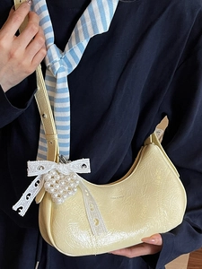 French style pale yellow crescent underarm bag with pleated patent leather and bow detail