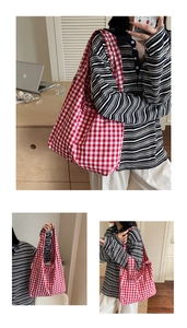 Detail shot of the red and white checkered canvas tote bag in a cozy home office setting