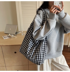 Macro shot of large black and white checkerboard canvas tote bag for daily commuting