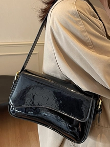 Classic black patent leather shoulder bag with gold hardware for elegant office commuters