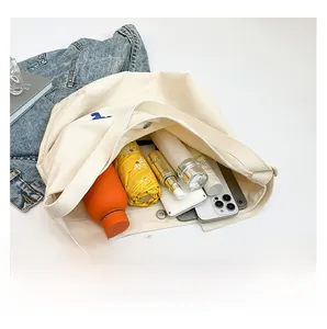Top view of cream canvas tote bag showing large capacity for umbrella and water bottle