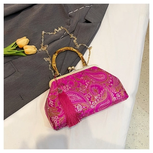 Detail of rose purple embroidery handbag featuring bamboo handle and long silk tassel